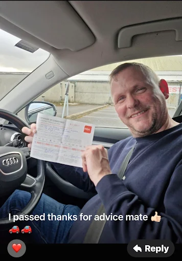 Student holding RSA driving test pass certificate next to BP Driving School Opel Corsa